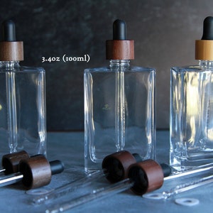 Compte-gouttes rectangulaire en verre de 3,4 oz (100 ml) | Bouteille transparente | avec pipette graduée en verre | Choisissez la couleur du bonnet en bambou | Emballage cosmétique