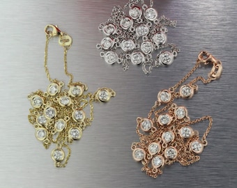 May include: Three delicate necklaces with round diamond accents. The necklaces are made of gold, rose gold, and silver chains.