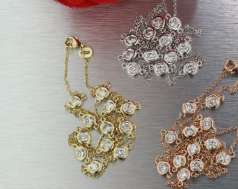May include: Three delicate necklaces with round diamond accents. The necklaces are made of gold, rose gold, and silver chains.