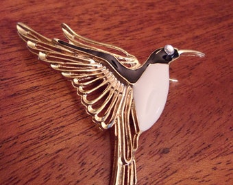 enameled hummingbird brooch,gold tone metal,black and white enamel,clear crystal eye,no maker's mark,secure clasp,bird lovers,gift
