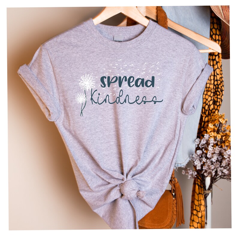 May include: Gray t-shirt with a white dandelion design and the text "spread kindness" in dark blue.