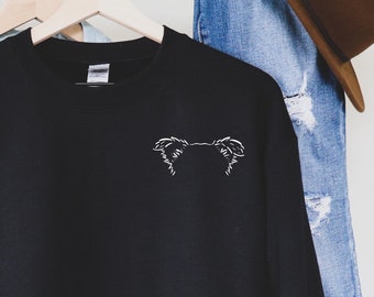 May include: Black sweatshirt with a white outline of a dog's head on the front.