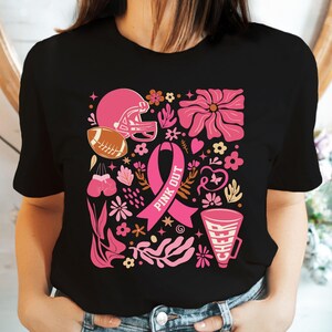May include: Black t-shirt with a pink ribbon, football helmet, flowers, and the text "Pink Out".