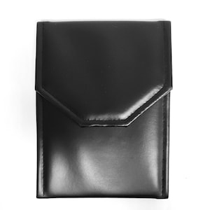 May include: A black leather jewelry box with a flap closure and a stitched design.