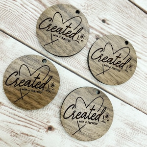 May include: Four round wooden ornaments with the text "Created with a purpose" and a heart design. Each ornament has a small hole for hanging.