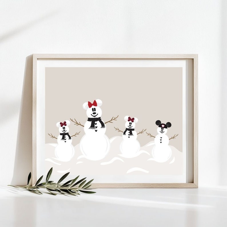 May include: A framed print featuring four snowmen with mouse ear-shaped heads. Each snowman has twig arms, a black scarf, and a red or black bow. The background is a neutral beige color, and the print is in a light wood frame.