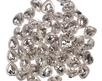 May include: A pile of silver heart-shaped metal buttons with a textured border.