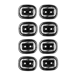 Könnte beinhalten: Acht schwarze rechteckige Knöpfe mit silbernem Rand und zwei Löchern.
