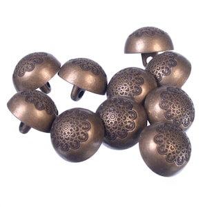 May include: A group of ten antique-looking metal buttons with a decorative floral design. The buttons are a dark bronze color and have a raised design.