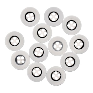 May include: Twelve white round buttons with five black holes in the centre of each button.