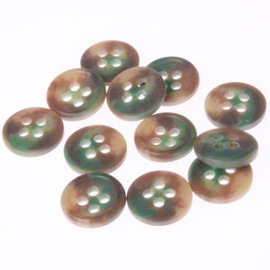 May include: A group of 12 brown and green camouflage buttons with four holes each.