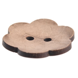 May include: A brown, two-hole, flower-shaped button with a dark brown edge.
