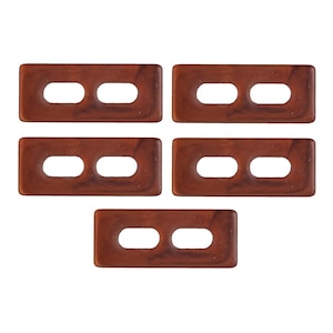 May include: Five rectangular brown buttons with two oval holes each, arranged on a white background. The buttons have a marbled appearance, suggesting a natural material like wood or a composite.