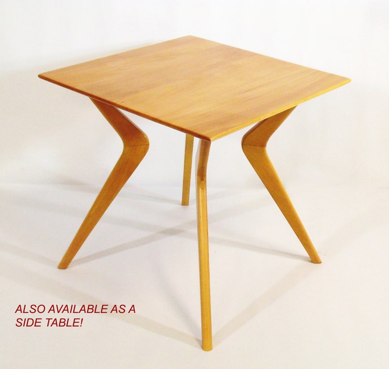 May include: A light wood side table with a square top and four angled legs. The table is made of solid wood and has a natural finish.