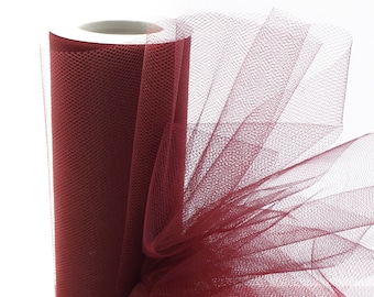 May include: A roll of burgundy tulle fabric. The tulle is a fine, sheer mesh fabric with a delicate texture.