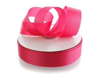 May include: A roll of bright pink satin ribbon, with a portion unrolled and looped. The ribbon is a vibrant fuchsia color, and the spool has a white core. Ideal for crafts, gift wrapping, and decorative projects.