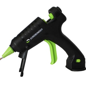 May include: A black and green hot glue gun with a trigger and a stand. The glue gun has the text "SUREBONder" on the side.