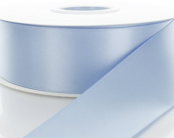 May include: A roll of light blue satin ribbon. The ribbon is smooth and shiny.