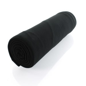 May include: A black fleece blanket rolled up into a cylindrical shape.