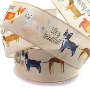 May include: Beige ribbon with a repeating pattern of dogs and the text "Life is beautiful!" printed on it.