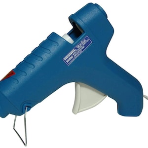 May include: A blue hot glue gun with a white trigger and a black warning label that says "WARNING: Hot Glue Gun - Use with caution".