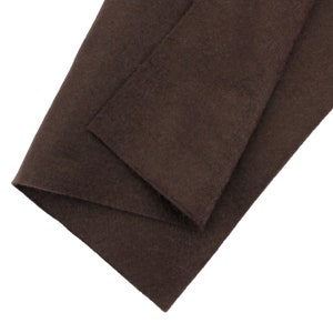 May include: Brown felt fabric folded in half, showing the texture of the material.