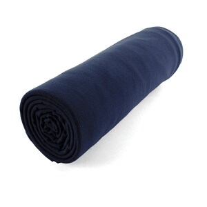 May include: A rolled up navy blue fleece blanket. The blanket is soft and warm, ideal for snuggling up on the sofa or taking on a camping trip.