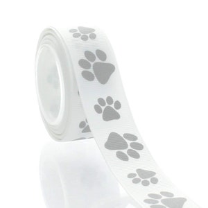 May include: White ribbon with a repeating pattern of grey paw prints.