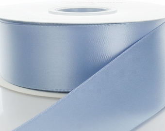 May include: A spool of light blue satin ribbon. The ribbon is smooth and shiny.