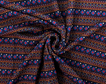 May include: Blue fabric with a repeating geometric pattern in red, yellow, and white. The fabric is folded and draped.