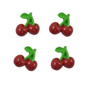 May include: Four red cherries with green stems and leaves. The cherries are arranged in pairs, with each pair facing the same direction.