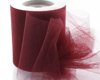 May include: A roll of burgundy tulle fabric. The tulle is a fine, sheer mesh fabric often used for crafts, decorations, and clothing.