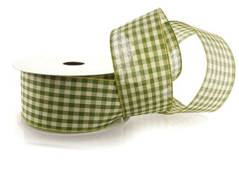 May include: A spool of green and white gingham ribbon. The ribbon is on a white spool and is rolled up.