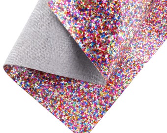 May include: A sheet of colorful glitter fabric with a white backing. The glitter is a mix of red, pink, blue, green, gold, and silver.