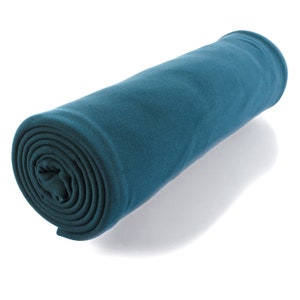 May include: A rolled up teal blue fleece blanket. The blanket is soft and cozy, perfect for snuggling up on the couch.