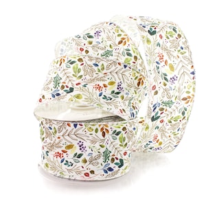 May include: A roll of white ribbon with a colorful floral pattern featuring leaves, berries, and branches. The ribbon is on a spool and is ready to be used for crafting, gift wrapping, or decorating.