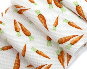 May include: White fabric with a repeating pattern of orange carrots on a white background. The fabric is textured and has a waffle-like appearance.