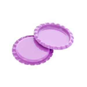 May include: Two lilac bottle caps with a shiny surface and a crimped edge. One cap is slightly open, revealing the interior. The caps are set against a clean white background.