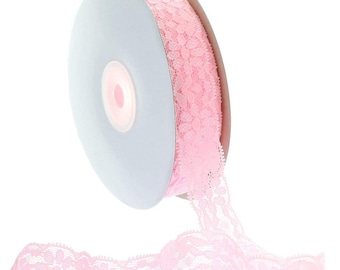 May include: Pink lace ribbon spool with a floral pattern. The ribbon is rolled up on a white spool.