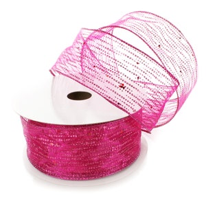 May include: A spool of pink iridescent ribbon with glitter. The ribbon is wrapped around a white cardboard spool.