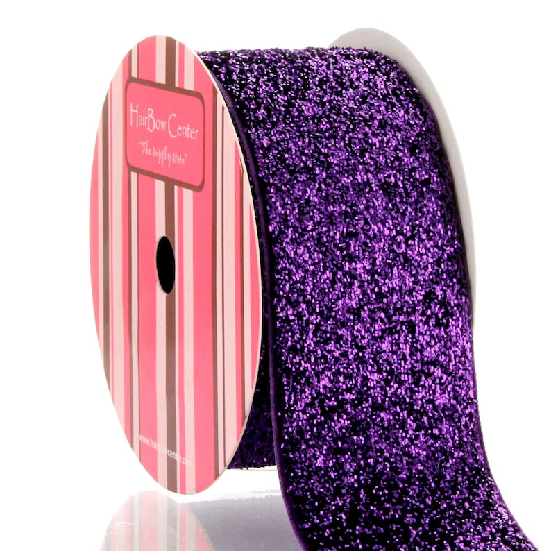 May include: A roll of purple glitter ribbon with a pink and brown striped label that reads "Hair Bow Center - The Simply Chic Store".