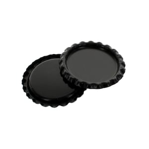 May include: Two black metal bottle caps with a scalloped edge.