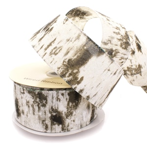 May include: A roll of wired ribbon with a birch bark pattern. The ribbon is white with brown accents and has a subtle shimmer. The ribbon is on a spool labeled "Wired Ribbon".