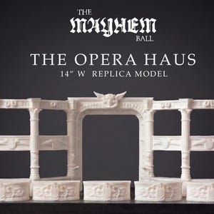May include: A white replica model of The Opera Haus, 35.5 cm wide, with ornate architectural details. The model features columns, arches, and decorative elements, set against a dark background. The Mayhem Ball is written at the top.