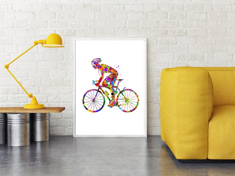 May include: A colorful watercolor painting of a cyclist riding a bicycle. The cyclist is wearing a helmet and the bicycle has two wheels. The painting is on a white background.
