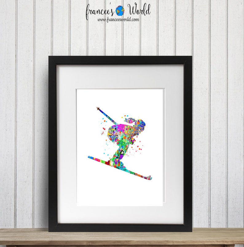K&ouml;nnte beinhalten: Ein farbenfrohes Aquarellbild einer Person beim Skifahren. Das Bild ist in einem schwarzen Rahmen und auf wei&szlig;em Hintergrund.