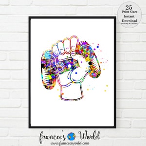 May include: A colorful watercolor illustration of a hand holding two video game controllers. The controllers are painted in a variety of bright colors, including red, blue, green, yellow, and purple. The hand is also painted in a variety of colors, and the background is white.