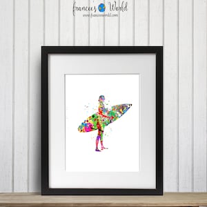Puede incluir: Una pintura acuarela colorida de una persona surfeando en una ola. La pintura est&aacute; en un marco negro y est&aacute; sobre una superficie de madera.