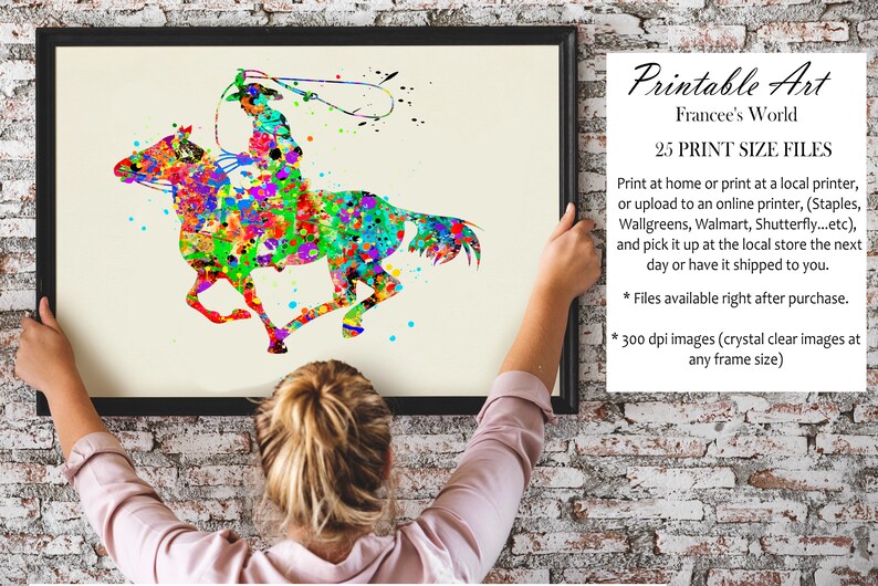 May include: A framed watercolour print depicting a cowboy on horseback, created in a vibrant splatter-paint style. The artwork shows a cowboy with a lasso, riding a horse, using a colourful palette of red, green, blue, and yellow. The print is labelled "Printable Art".