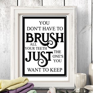 May include: A white framed print with black text that reads "You don't have to brush all your teeth just the ones you want to keep".